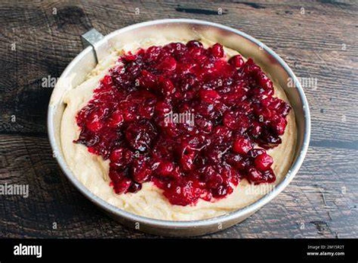 Cranberry cake batter in a bowl and in a baking dish.