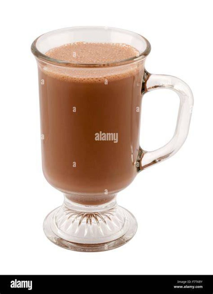 Hot chocolate in a glass topped with marshmallows.