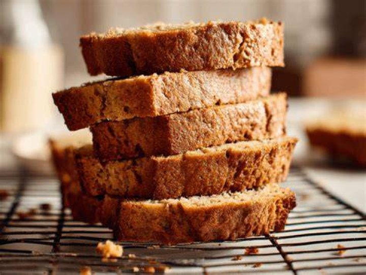 Stack of banana bread slices on a white plate.