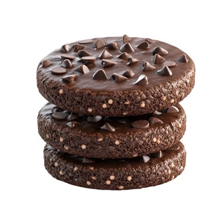 Three chocolate cookies stacked on a white plate.